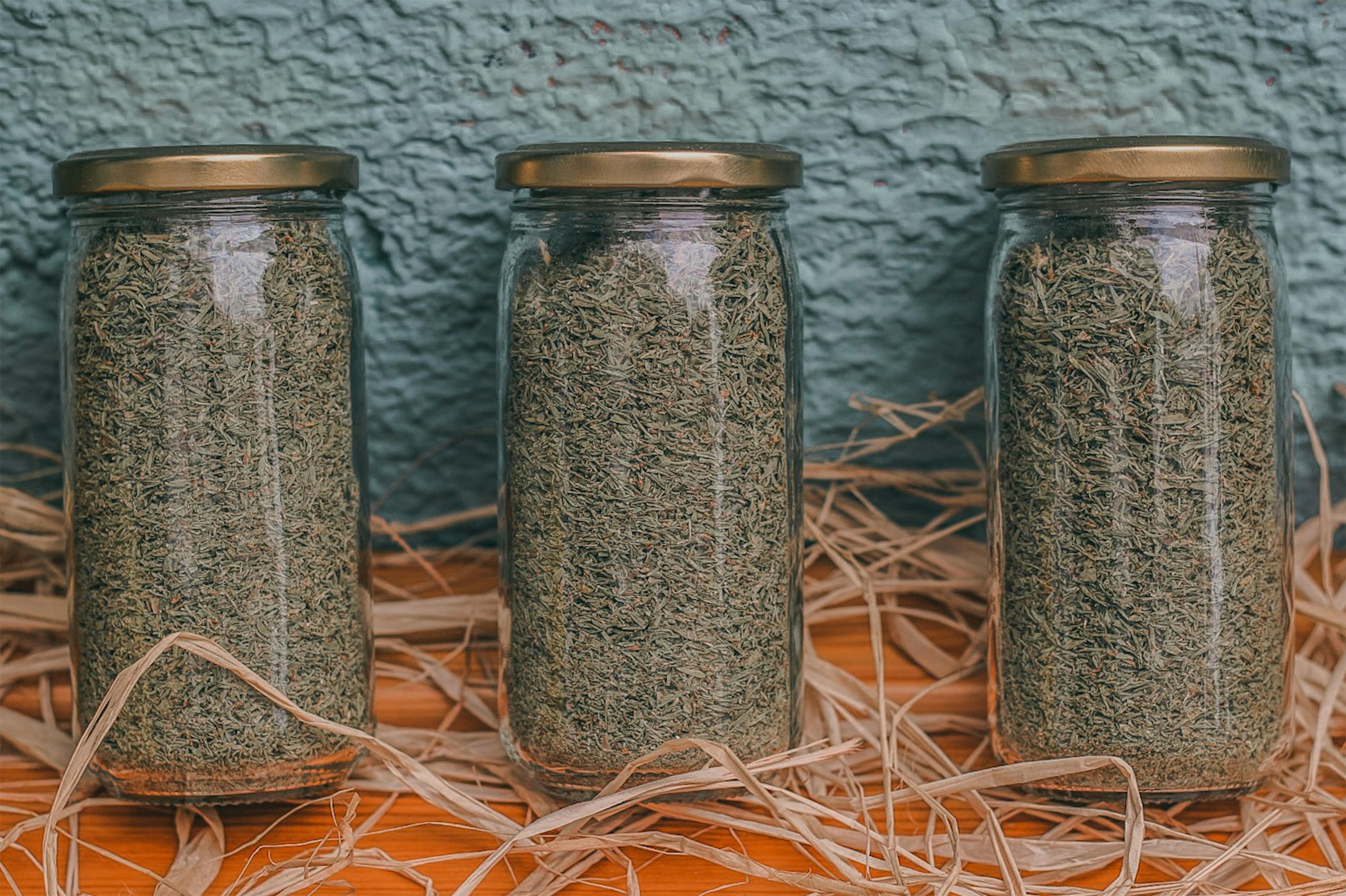 Glass jars of dried herbs in storage